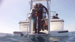 Why do scuba divers fall backwards