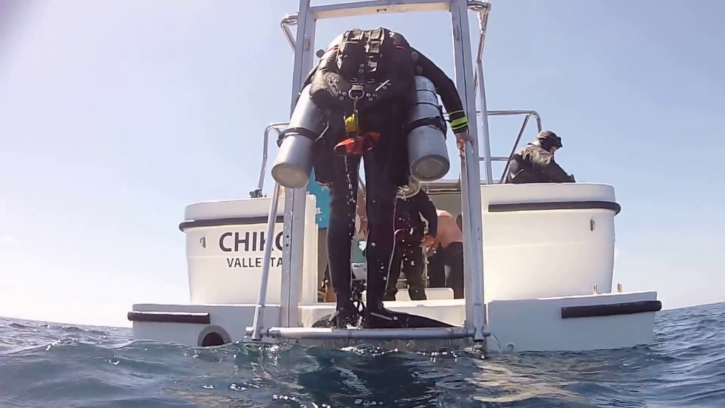 Why Do Scuba Divers Fall Backwards