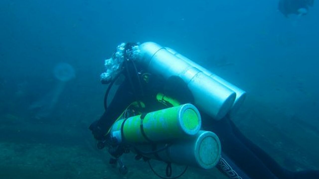 Why is helium used in scuba diving?